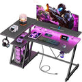 Korfile 40 Inch Gaming Desk with Power Outlet & LED Lights, L Shaped Computer Gaming Table with 3 Tiers Storage Shelves, Corner Gamer Desk with Monitor Stand for Small Space, Carbon Fiber Black by Korfile